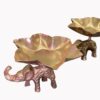 Golden elephant-shaped tealight holders with petal-like trays, arranged in a decorative set for festive occasions.