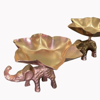 Golden elephant-shaped tealight holders with petal-like trays, arranged in a decorative set for festive occasions.