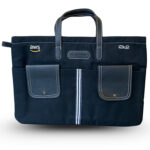 Black office laptop bag with AWS and i2k2 logos, multiple front pockets, stitched handles, and a central zipper designed for business professionals.