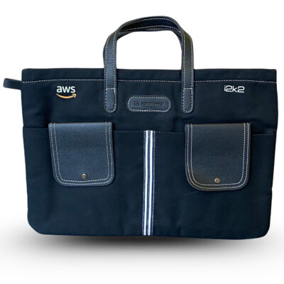 Black office laptop bag with AWS and i2k2 logos, multiple front pockets, stitched handles, and a central zipper designed for business professionals.